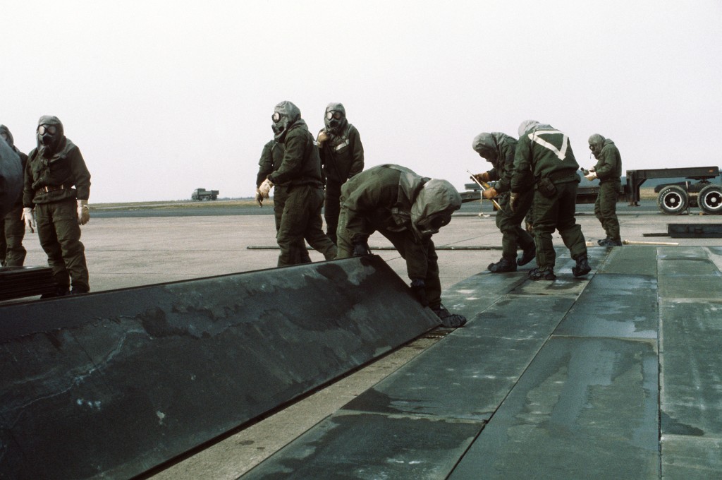 Members of the 50th Civil Engineering Squadron repair a simulated bomb crater